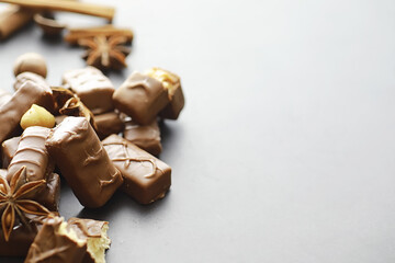 Chocolate bars on a black background in backlight. Chocolate with filling. Sweet sweets for snack and tea.