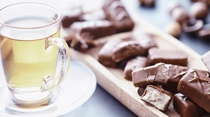 Chocolate bars on a black background in backlight. Chocolate with filling. Sweet sweets for snack and tea.