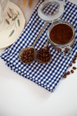 Breakfast top view. Coffee grains poured from a can on kitchen table. Coffee cup mood. Coffee bean, Food background. Still life with copy spase.