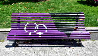 Gay pride bench at public park. Colours of lesbian pride flag. A Coruña, Galicia, Spain.