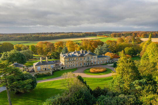 Bowcliffe Hall Yorkshire stately home, wedding venue and offices close to the A1, York, Leeds and Bramham Park. Drone photo showing the front of the main building and trees on an autumn day