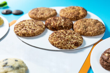 Tasty chocolate cookies on the blue background, close up