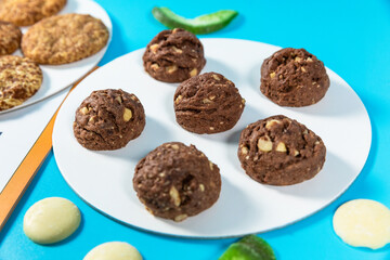 Tasty chocolate cookies on the blue background, close up