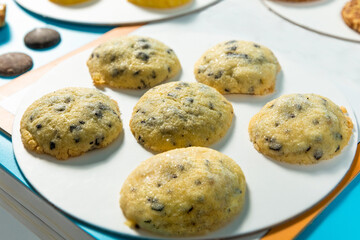 Tasty yellow cookie on the blue background, close up