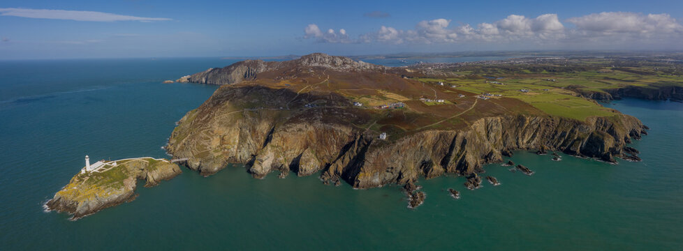 Panoramic photo of South Stack Lighthouse near Holyhead Anglesey aerial taken from out at sea showing the island and rocky cliffs