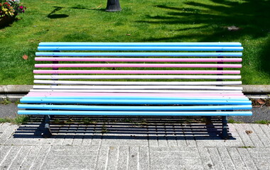 Gay pride bench at public park. Colours of transgender pride flag. A Coruña, Galicia, Spain.