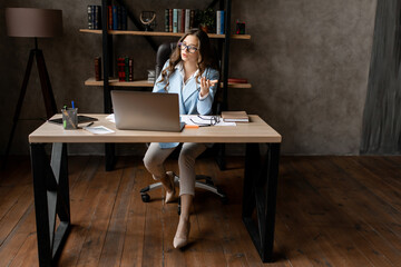 Young beautiful business lady have a video call with partners in the office