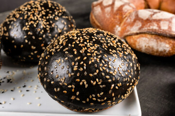 Fresh dark, black burger bread close up