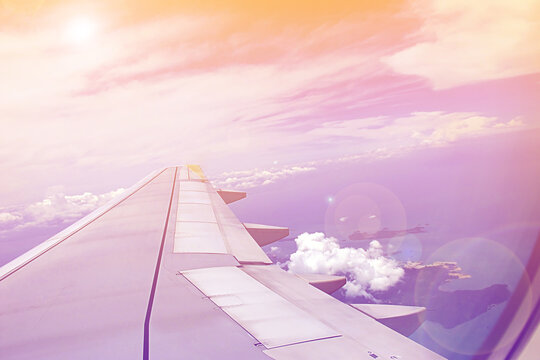 Arial Sea Island View From Window Plane Above The Clouds In Sweet Pastel Color Effect Style With Sun Light Ray Flare