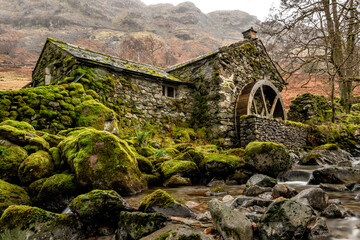 Borrowdale Mill in the winter in the Lake District National Park England. Green moss on the rocks surrounding the old watermill near Keswick and Buttermere © Chris Chambers
