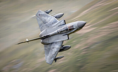 RAF (Royal Air Force) Panavia Tornado GR4 Fighter Bomber and reconnaissance jet flying low level in the UK, Cumbria, Wales and Scotland.  