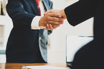 Business people shake hands with business partnership.