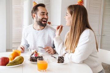 Cheerful attractive young couple celebrating birthday