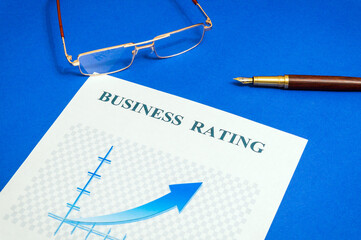 The business rating chart on the green office desk with notebook and stylish pen, business idea
