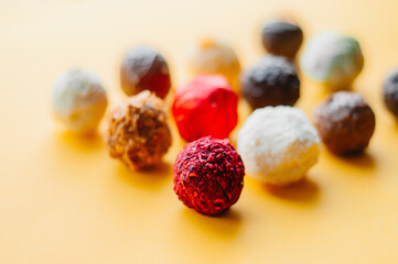 Brigadeiro Gourmet Chocolate Ball Traditional Brazilian sweet made with Milk Chocolate Pistachio Pink Peanuts White Dark Lemon in tower trays and white bowl