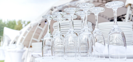 Catering services. closeup Glasses without wine and plates background at outdoor party.