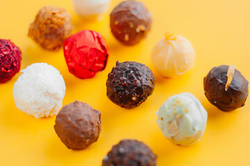 Brigadeiro Gourmet Chocolate Ball Traditional Brazilian sweet made with Milk Chocolate Pistachio Pink Peanuts White Dark Lemon in tower trays and white bowl