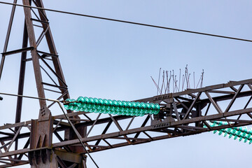 Power transmission tower closeup - high voltage electricity pole of the grid
