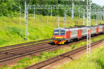 Naklejka premium Suburban electric train on a sunny summer day. Soft focus.