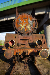 Fototapeta na wymiar Old, rusty steam locomotive standing on the station