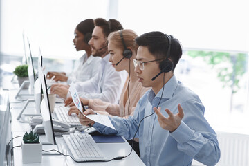 Frustrated hotline operator dealing with client problem in call centre office