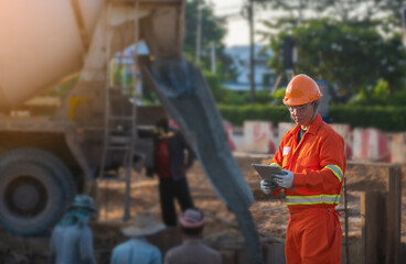 Civil engineering is controlling workers pouring cement for road construction.
