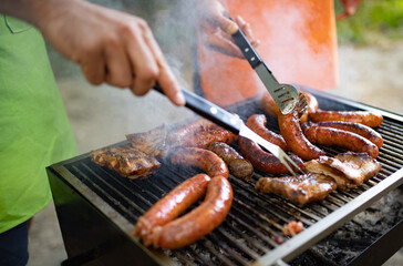 Delicious sausages on the barbecue grill outdoor