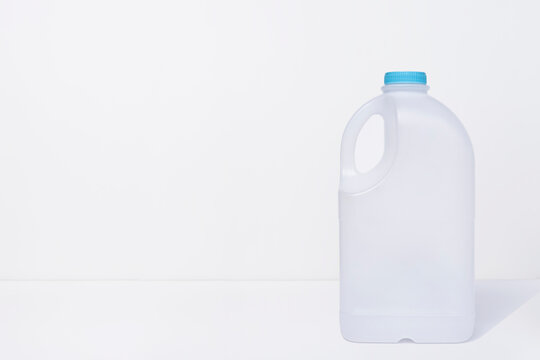 Empty elastic milk gallon container on white background Stock Photo | Adobe  Stock