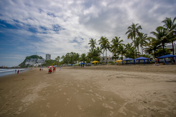 Beautiful view of the beach with sand, and buildings behind in a beautiful day in with sunny weather in a blue sky in Same, Ecuador