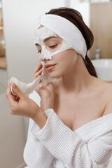 Facial Mask. Woman Applying Cosmetic Alginate Mask