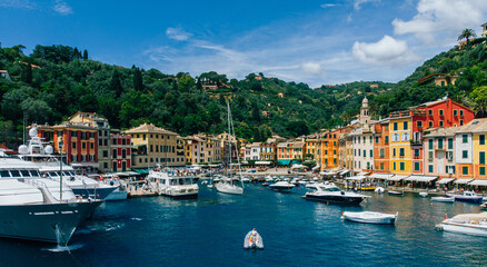 Fototapeta na wymiar Aerial view of sea bay with beautiful picturesque village called Portofino, famous touristic destination. .Small marina port at the foot of mountain with a beautiful colourful houses village