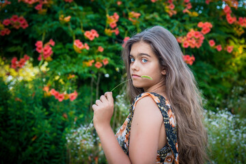 Fototapeta premium Portrait of a beautiful smiling girl. Happy girl in summer. Summer girl closeup. Smiling girl with long hair 