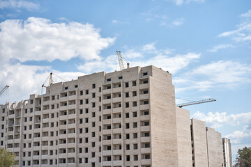 Fototapeta na wymiar Crane building construction site blue cloudy sky background