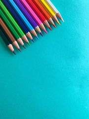 Back to school, color pencils in a blue background