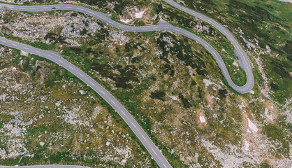 Bird's eye view of serpentine curves. Top aerial view of scenic route in Austria with name Grossglockner High Alpine Road. Some of hairpin turns of Hochtor Pass