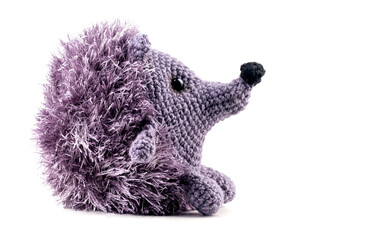 Knitted isolated hedgehog baby toy on a white background. Cute plush toy for children handmade. © flame4hell