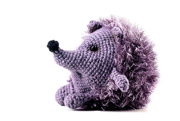 Knitted isolated hedgehog baby toy on a white background. Cute plush toy for children handmade.