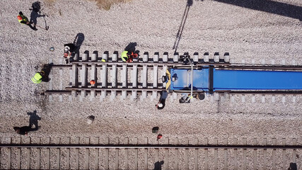 Railroad workers repairing a broken track. Repairing railway. Rail tracks maintenance process.
