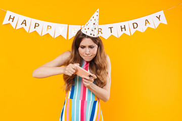 Image of stressed cute woman playing online game on cellphone