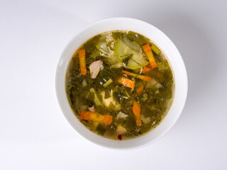 Vegetable homemade sorrel soup. Round white bowl on a white background