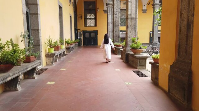 A nun walks in the convent in the Monastery of San Gregorio Armeno in Naples, Italy