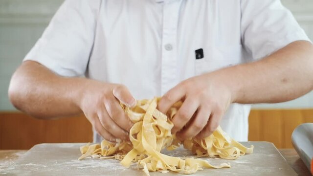 Chef cooks prepares homemade pasta, italian handmade macaroni cooking.