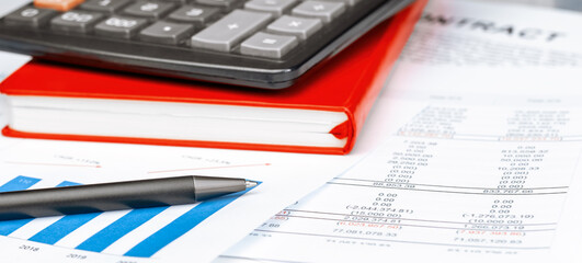 Calculator on financial papers at the table close up. Finance concept