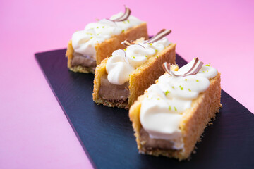 Le Coco cake with duo chocolate, lime cream, coconut and crunchy layer in front