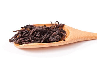 Famous chinese oolong tea da hong pao in the bamboo scoop isolated on a white background.