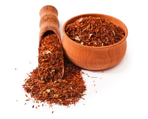 Rooibos tea in a wooden scoop and  wooden bowl  isolated on a white background 