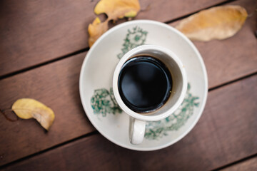 cup of coffee on a wooden table in autumn