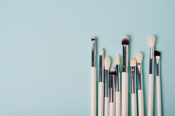 Makeup brushes on a blue background close up