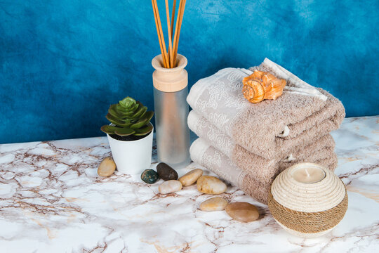 Spa objects and elements on a marble table and blue background