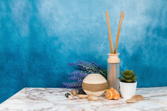 Spa objects and elements on a marble table and blue background